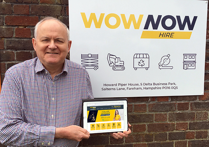 WowNow Hire CEO Jonathan Holley with sign and tablet